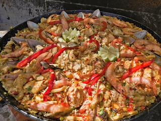 large traditional Tenerife paella with meat, prawns, mussels,