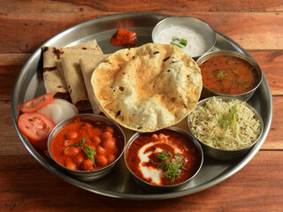 Punjabi Veg Thali from an indian cuisine, food platter consists variety of veggies, lentils, jeera...