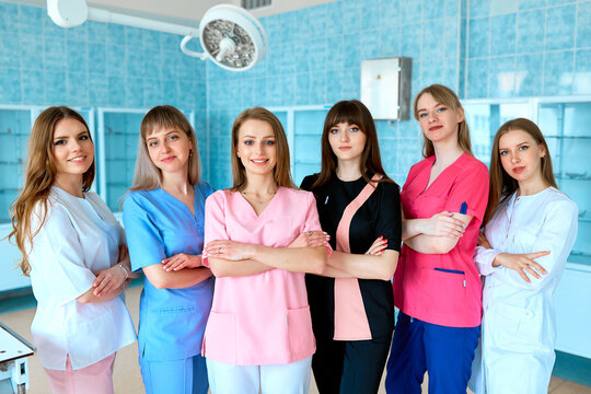 Medical students. Surgeons in the operating room. A group of young female doctors in colorful surgical suits. The concept of medical education. - Powered by Adobe
