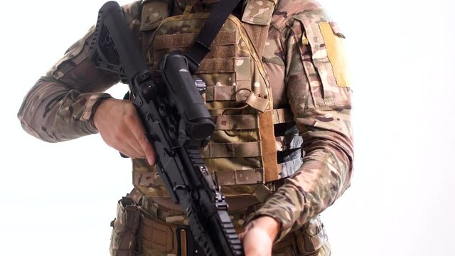 Special Forces scout wearing a multicam tactical outfit with a flak jacket and a combat rifle in his hands rotates 180 degrees. White background 