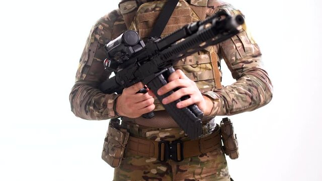 Navy SEAL in a cartoon color tactical gear and wearing a bulletproof vest reloads the magazine of a combat carbine. White background