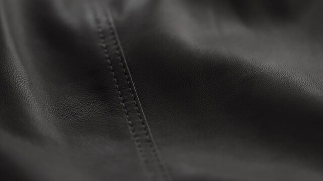 Slow motion handheld shot of soft gray brown leather closeup