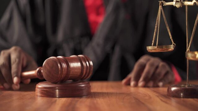 Rack focus from hammer to reforms, Concept showing of judicial reforms - judge at court after hitting gavel pushing reforms sign board.