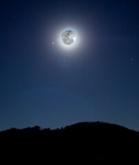 Fototapeta na wymiar full moon over mountain at night