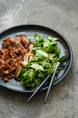 Close view of soy protein meat with green salad