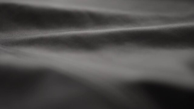 Slow motion handheld shot of soft gray brown leather closeup