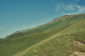 Fototapeta na wymiar Scenic view of green meadows Dagestan, Russia