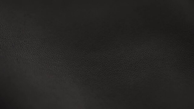 Slow motion handheld shot of soft gray brown leather closeup