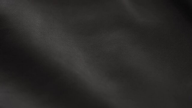 Slow motion handheld shot of soft gray brown leather closeup
