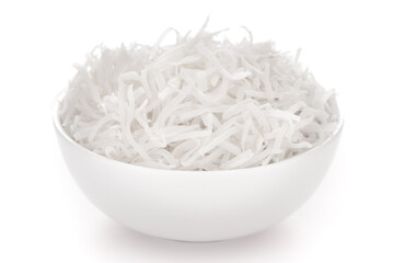 Close-up of white dry  shredded organic coconut in a white ceramic bowl over white background.