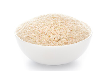 Close-up of medicinal organic isabgol husk or psyllium husks  (Plantago ovata)  in a white ceramic bowl over white background.