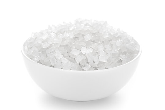 Close-up of organic  crystalline rock sugar candy (misiri or mishiri)  in a white ceramic bowl over white background.