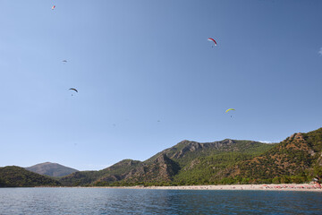 Oludeniz coastline with flying paragliders in sky