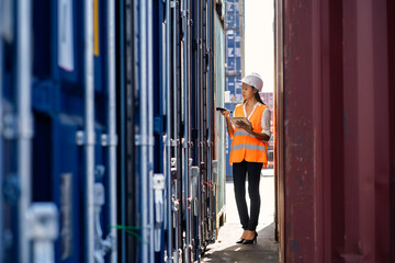 Engineers are overseeing the transportation of cargo with containers inside the warehouse. Container in export and import business and logistics.