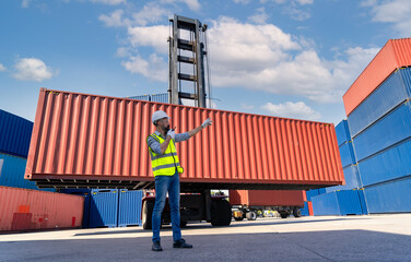 Engineers are overseeing the transportation of cargo with containers inside the warehouse. Container in export and import business and logistics.