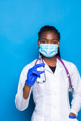 healthcare, vaccination, anesthesia and medical concept - african american female doctor holding syringe with injection isolated over blue background
