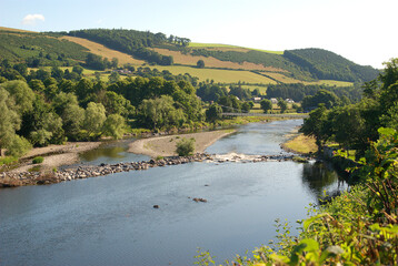 view of river Tweed hills and chain bridge at Melrose in summer
