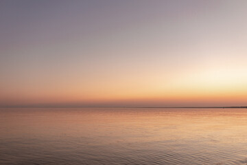 sunset sun by the ocean, clear water and sandy azure beach