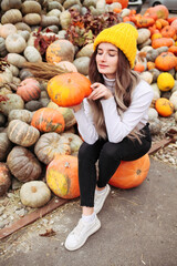 Fototapeta premium Young pretty woman holding orange halloween pumpkin. 