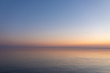 sunset sun by the ocean, clear water and sandy azure beach