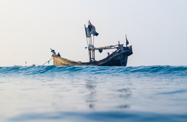 Naklejka premium Photo of Industrial fishing boat. Fishing boat in the sea. The fishing industry in Bangladesh. Bangladeshi traditional fishing boat on St. Martin's Island.
