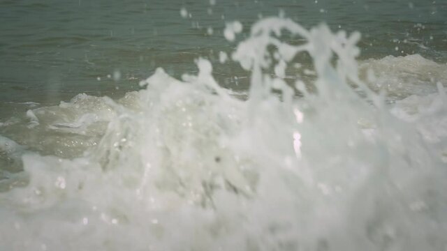 Close up of a wave hitting the rocky coast, slow motion.