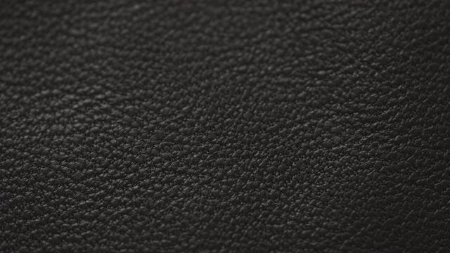 Slow motion handheld shot of soft gray brown leather closeup