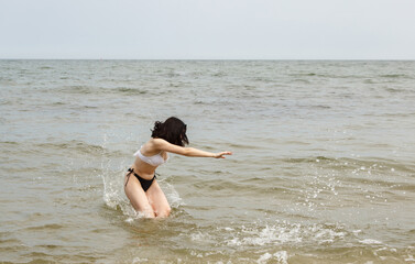 young woman swims in the sea