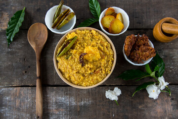 Dal khichadi or khichdi a delicious Indian recipe made of yellow dal or lentils and rice . Selective focus. It is generally accompanied with fried vegetables. Top view.