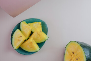 Yellow watermelon on a pink and green background.
Creative background of summer fruits. Food concept. Flat lounger, top view, copy space
Sectional seasonal fruits. Fresh fruit harvest.