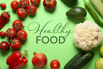 Fresh vegetables and fruits with text HEALTHY FOOD on color background