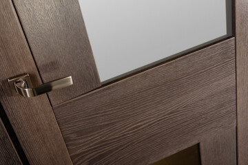 Part of oak wooden door with stylish metal handle