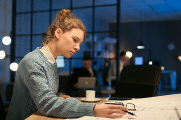 Beautiful woman working in office at night