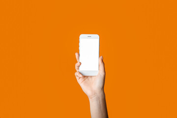 Female hand and mobile phone on color background