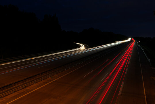 Lightrays from driving cars on the highway at night