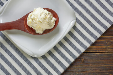 Balkan cuisine. Wooden spoon with kaymak - local soft white cheese.  Montenegro