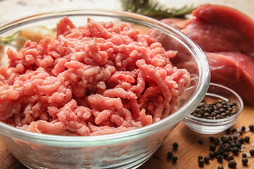 Bowl with fresh forcemeat on table, closeup