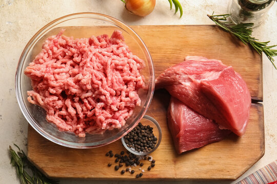 Bowl with fresh forcemeat and ingredients on table