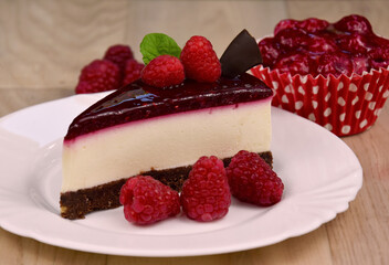 Delicious creamy raspberry cake stock images. Slice of cheesecake with jelly topping, raspberries and mint leaf still life stock photo