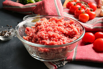 Bowl with fresh forcemeat on dark background