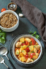 The concept of Diet menu. Homemade turkey or chicken with pineapple sauce and boiled spelled on a dark stone table.