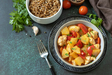 The concept of Diet menu. Homemade turkey or chicken with pineapple sauce and boiled spelled on a dark stone table. Copy space.