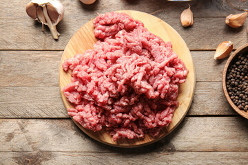 Board with fresh forcemeat on wooden background