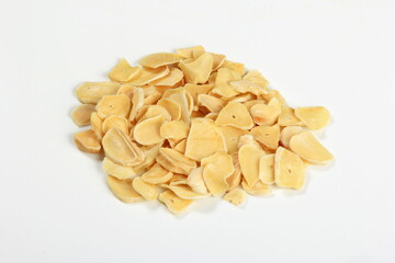 Dried garlic flakes on white background. Dried vegetables