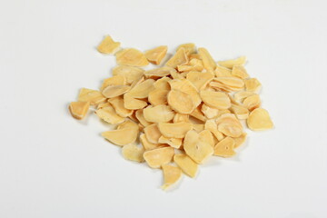 Dried garlic flakes on white background. Dried vegetables
