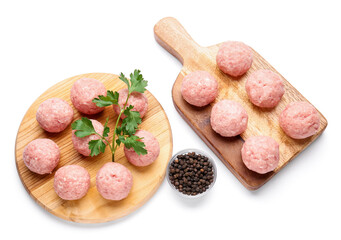 Wooden boards with raw cutlets made of fresh forcemeat on white background
