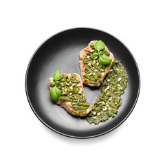 Plate with tasty steaks an pesto sauce on white background