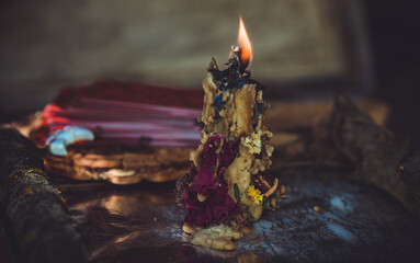 Candle burns on the altar, magic among candles, clean negative energy, wicca concept