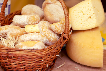 Different types of cheeses. Collection of cheese in wicker basket