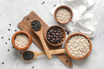 Different types of beans on light background